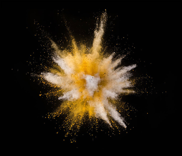 Explosion of yellow powder isolated on black background. Abstract colored background - Photo, Image