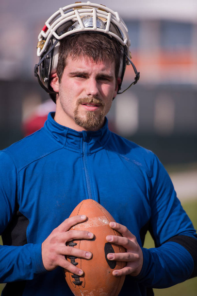 portrait of young confident American football player  standing on a field during the training - Fotoğraf, Görsel