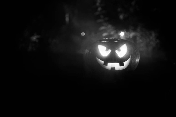 Halloween pumpkin. Carved Halloween pumpkin glowing in the dark. Outdoor shot - Фото, зображення