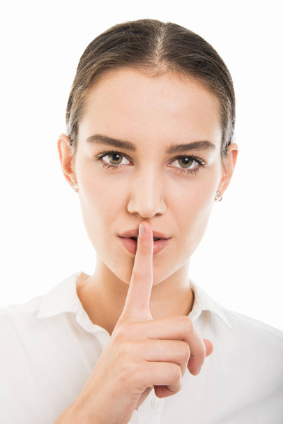 Close-up of young pretty business woman showing silence gesture isolated on white background - Fotoğraf, Görsel
