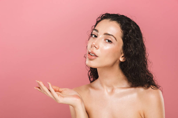 Portrait of amazing beautiful young woman with healthy skin posing isolated over pink background looking aside. - Foto, immagini