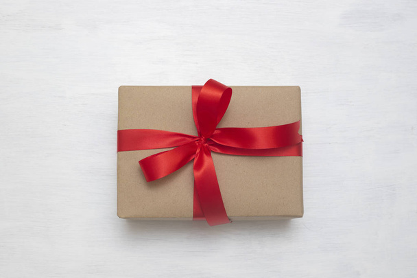 Brown gift box with red ribbon isolated on white background to send the good feeling to special one - Photo, Image