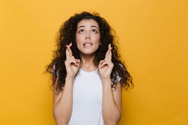 Photo of beautiful excited young cute woman posing isolated over yellow background showing hopeful please gesture. - Φωτογραφία, εικόνα