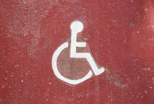 Disability icon on grunge background, floor of underground garage . - Photo, Image