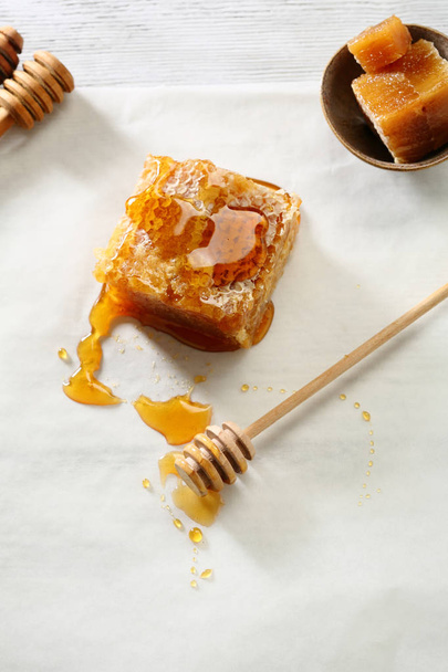 Honey comb and stick on white - Photo, image