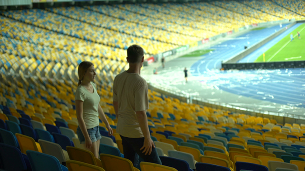 Paar verlässt Stadion nach Fußballspiel, leeres Stadion, Interesse am Sport - Filmmaterial, Video