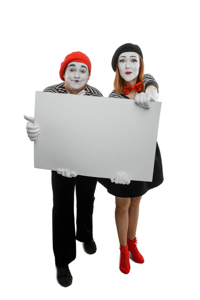Smiling mimes showing big card - Photo, image