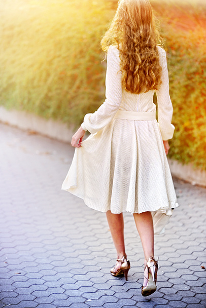 Fashion woman in autumn spring dress on city street . - Photo, Image