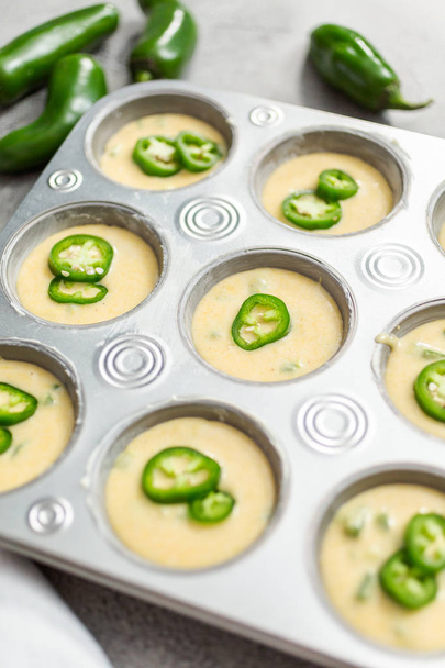 batter for cornbread muffins with spicy jalapeno pepper in muffin pan - Photo, Image