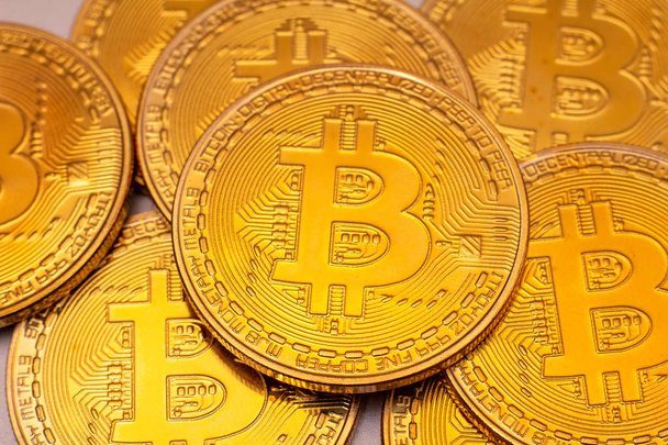 Golden Bitcoins on a gold background . Photo new virtual money Close-up - 写真・画像