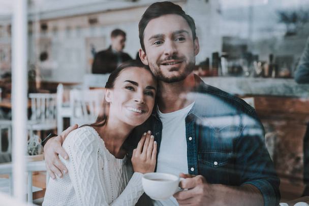 Hugging. Love. Drink Tea. Have Fun. Tea Party. Smiling People. Enjoyment. Guy and Girl. Bonding. Together in Cafe. Cheerful Girl. Happy Together. Leisure Time. Good Relationship. Happy Holidays. - Valokuva, kuva