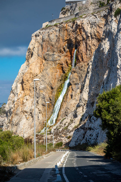 Waterfall flowing out of the Rock of Gibraltar - Фото, зображення