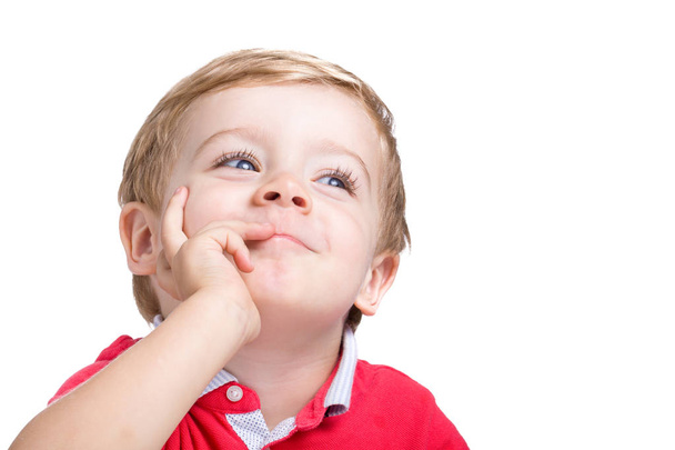 Adorable little boy thinking on white background - Foto, imagen
