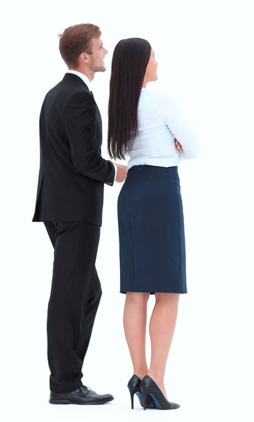 rear view. businessman and business woman standing next to and looking forward. - Foto, imagen