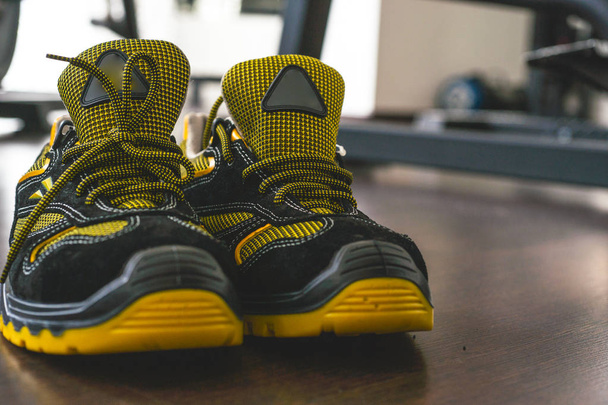 Unbranded modern sneaker in the gym. Black-Yellow. Comfortable shoes. - Photo, Image