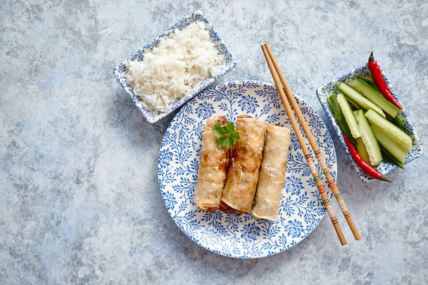 Orginal asian deep fried spring rolls placed on beautiful oriental style plate - Photo, Image
