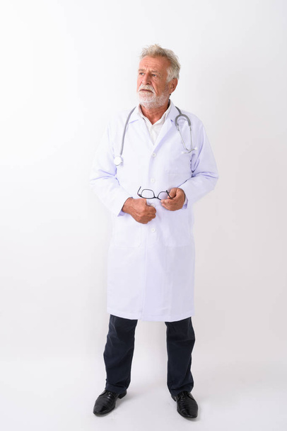 Full body shot of handsome senior bearded man doctor standing an - Фото, зображення