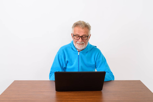 Studio shot of happy senior bearded man smiling while wearing ey - Photo, Image