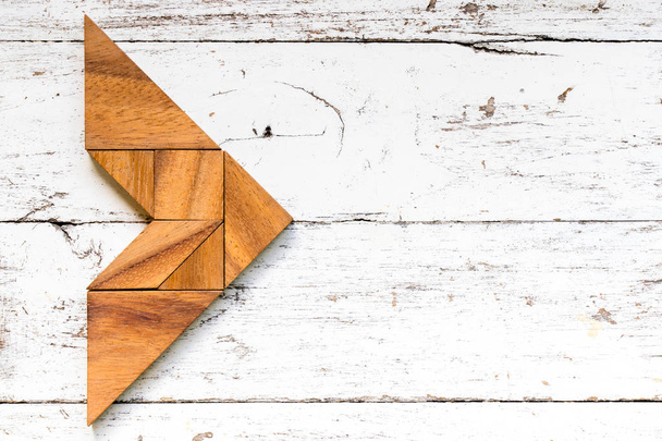Tangram Puzzle in Pfeilform auf altem weißem Holzhintergrund - Foto, Bild