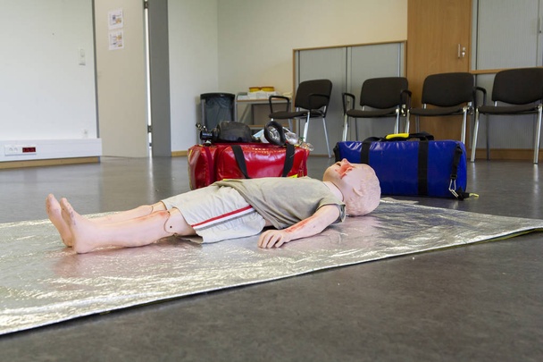 Medical teenager puppet lies injured on the ground - Photo, Image
