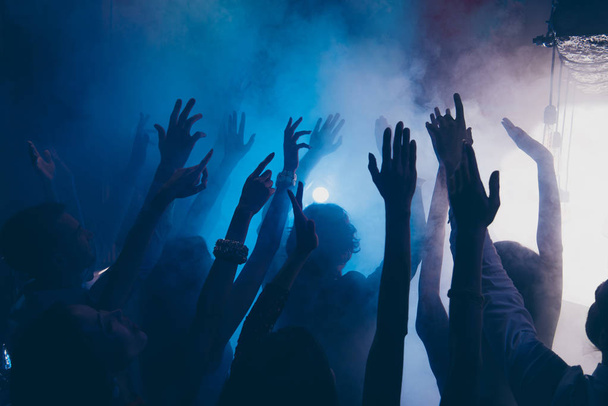 Close up cropped photo of people raised hands up in blue whire s - 写真・画像
