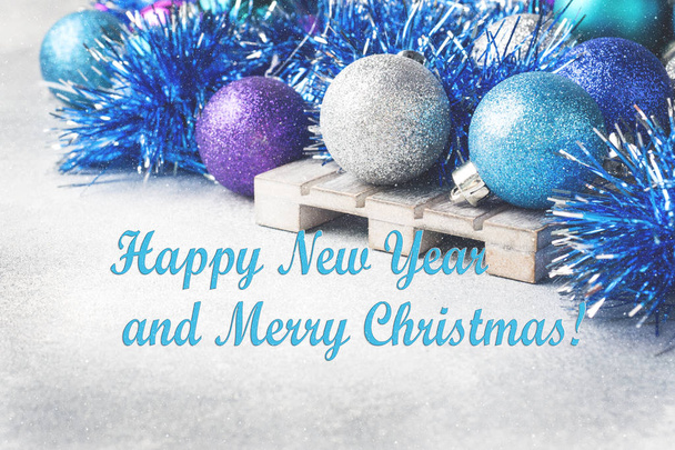 Blue Christmas balls and tinsel on grey background. New Year concept and scenery. - 写真・画像