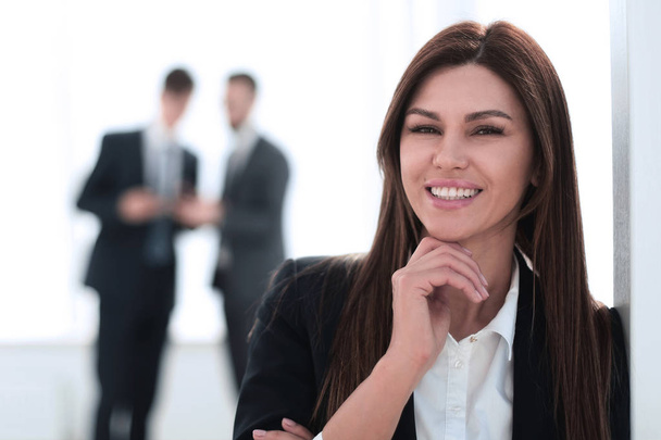 smiling business woman on blurred office background - Fotó, kép