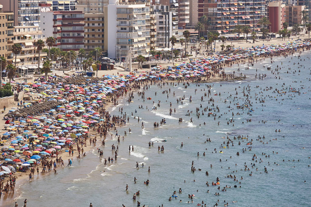 Mediterranean coastline in Spain. Calpe beach. Summer crowd. Alicante seascape - Photo, Image
