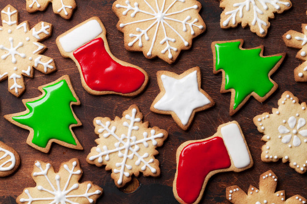 Christmas gingerbread cookies over wooden backdrop. Top view - Photo, Image