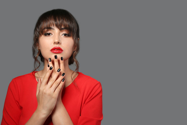 Beautiful young woman with professional manicure on grey background - Zdjęcie, obraz