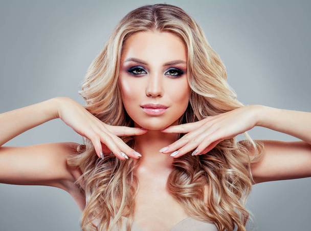 Perfect blonde woman face. Model with long healthy curly hair and makeup - Photo, Image