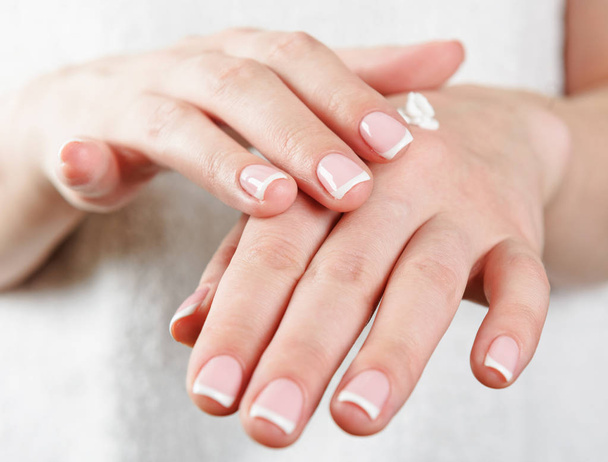 Beautiful woman's hands applying cream - Foto, afbeelding
