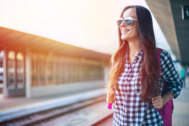 Young casual woman waiting for train on railway station - Φωτογραφία, εικόνα