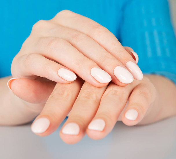 Beautiful female hand with beige nail design - Foto, immagini