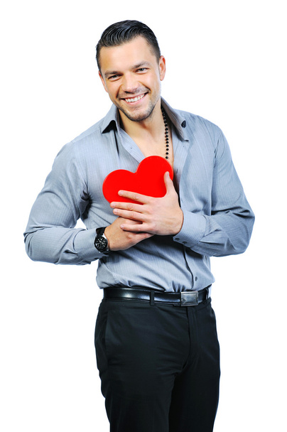 Beautiful handsome young macho man holding love heart and smilin - Foto, Bild