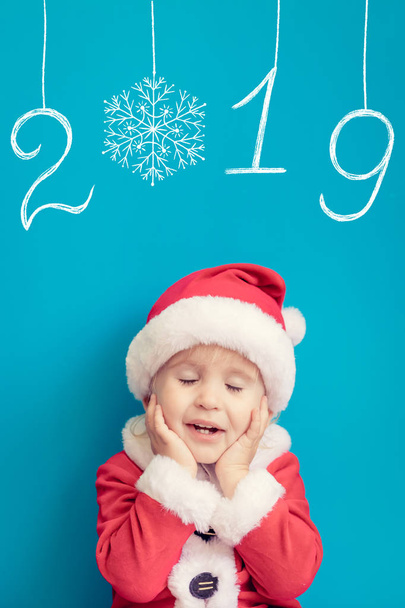Portrait of child wearing Santa Claus costume. Kid having fun at Christmas time. Merry Xmas concept - Photo, Image