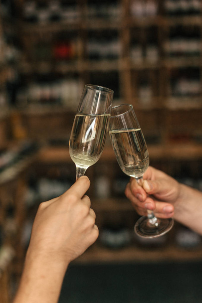 Male and female hands clicking glasses with champagne - Photo, Image