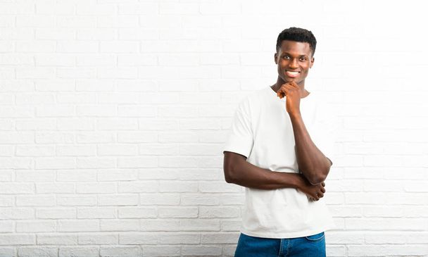Dark skinned man smiling and looking to the front with confident face - Photo, Image