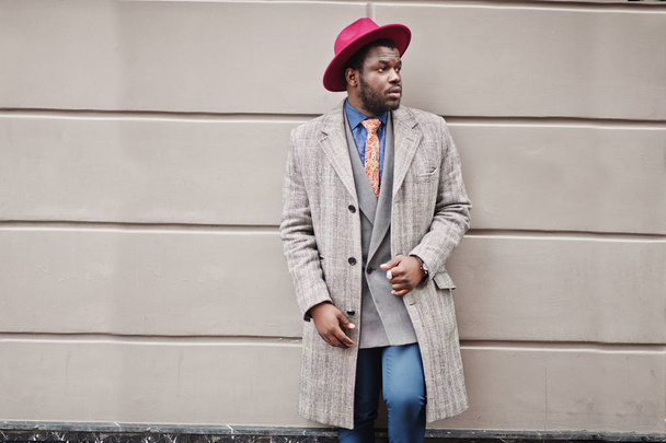 Stylish African American man model in gray coat, jacket tie and red hat.  - Foto, imagen