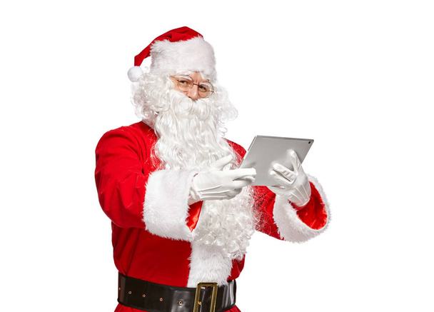 Santa Claus using tablet computer.  Isolate on white background. - Foto, afbeelding