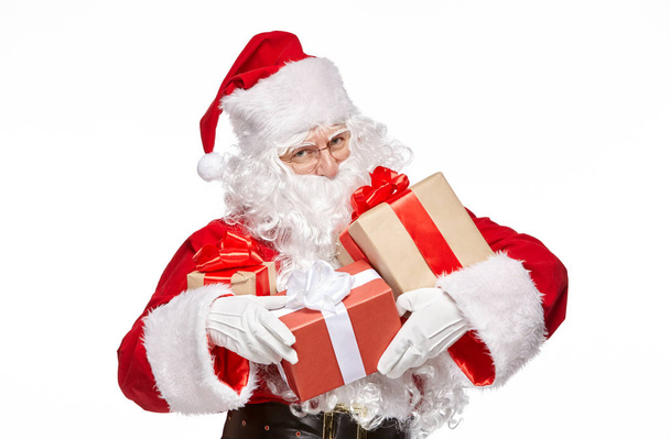 Happy Santa Claus is holding presents. Isolate on white background. - Zdjęcie, obraz