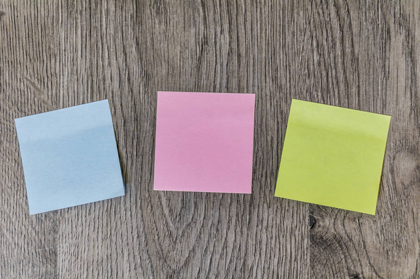Colorful Sticky Notes Pasted on a Wooden Background - Foto, Imagen