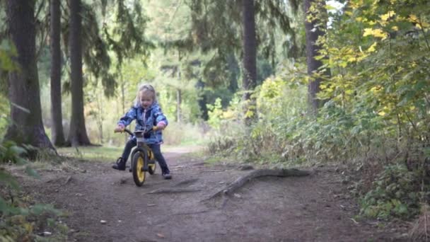 秋の森を駆け抜ける自転車の女の子 - 映像、動画