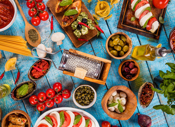Various kind of italian food served on wood. Top view, free space for text - Fotoğraf, Görsel