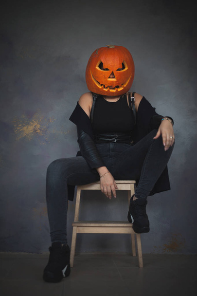Woman with carved pumpkin on her head for Halloween - 写真・画像