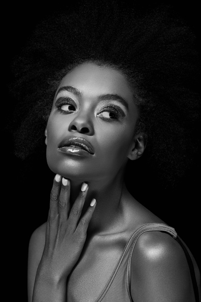 black and white photo of beautiful pensive african american woman isolated on black - Фото, изображение