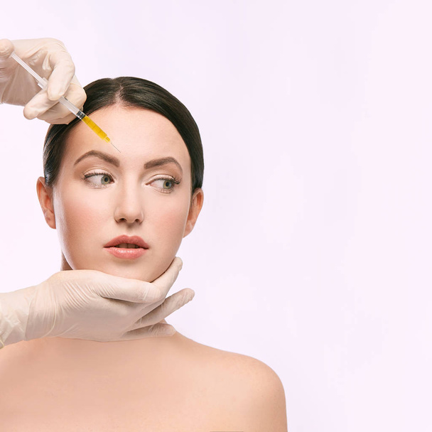woman face injection. salon cosmetology procedure. skin medical care.  dermatology treatment. anti aging wrinkle lifting. - Foto, Bild