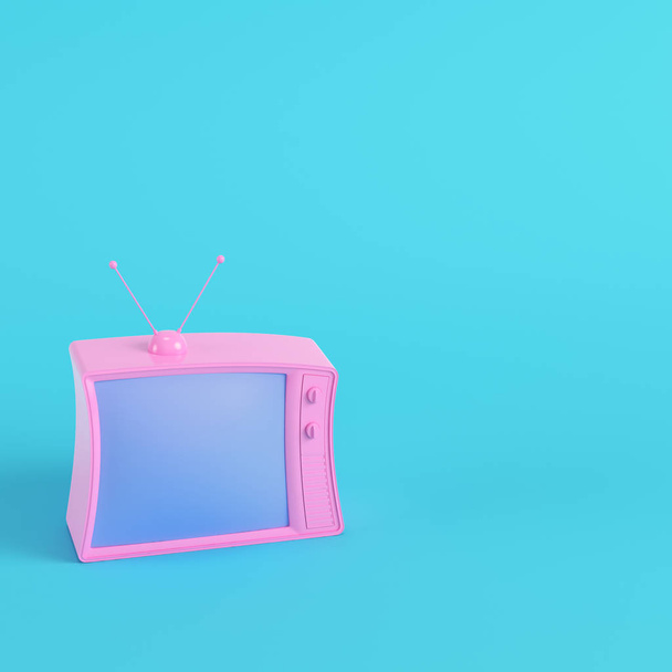 Pink retro styled tv on bright blue background in pastel colors. Minimalism concept. 3d render - 写真・画像