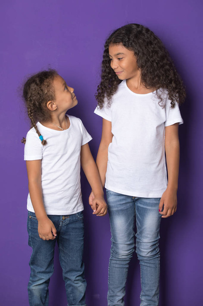 Cute little african american girls in white t-shirts. Mock-up. - Фото, изображение