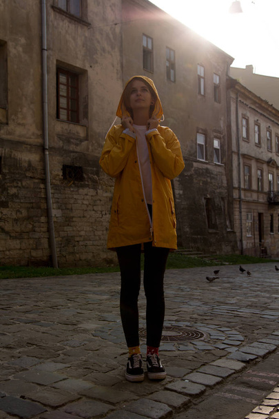 Happy girl in a yellow raincoat - Фото, зображення